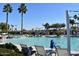 Relaxing pool area with plenty of lounge chairs and palm trees at 20301 N Queen Palm Ln, Surprise, AZ 85374