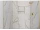 Marble shower with gold fixtures and a built-in niche at 20301 N Queen Palm Ln, Surprise, AZ 85374