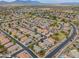 Aerial view showcases the expansive neighborhood, the streetscape, and mountain views at 20583 N Ryans Trl, Maricopa, AZ 85138