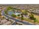Aerial view of community with a lake, a swimming pool, and a playground at 20583 N Ryans Trl, Maricopa, AZ 85138