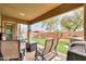 Covered patio with seating area, a fire pit, lush lawn and landscape at 20583 N Ryans Trl, Maricopa, AZ 85138