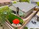 Backyard with covered patio and a seating area with red umbrella at 20583 N Ryans Trl, Maricopa, AZ 85138