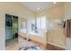 Bright bathroom with garden tub, walk-in shower with glass surround, and walk-in closet at 20583 N Ryans Trl, Maricopa, AZ 85138