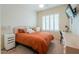 Comfortable bedroom with carpet, a window with shutters, and a small work space at 20583 N Ryans Trl, Maricopa, AZ 85138