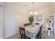 Traditional dining room boasts neutral walls, chandelier lighting, and a charming dining table set for six at 20583 N Ryans Trl, Maricopa, AZ 85138