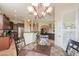 Dining area with a chandelier and view into the kitchen and living area at 20583 N Ryans Trl, Maricopa, AZ 85138