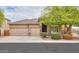 Charming single-story home with a three-car garage and well-manicured landscaping at 20583 N Ryans Trl, Maricopa, AZ 85138