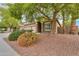 Landscaped front yard with lush green bushes and desert flora enhance curb appeal at 20583 N Ryans Trl, Maricopa, AZ 85138