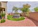 Relaxing backyard features a sleek hot tub, synthetic lawn, palm trees, and crushed-stone landscape for easy maintenance at 20583 N Ryans Trl, Maricopa, AZ 85138
