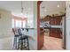 Kitchen with bar seating adjacent to a stainless steel oven and dark wood cabinetry at 20583 N Ryans Trl, Maricopa, AZ 85138