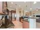 Spacious kitchen with stainless steel appliances, dark countertops and open floor plan at 20583 N Ryans Trl, Maricopa, AZ 85138