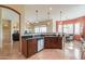 View of kitchen with stainless steel dishwasher, granite countertops and wooden cabinets at 20583 N Ryans Trl, Maricopa, AZ 85138