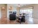 Spacious living room featuring large windows, tiled floors, a ceiling fan, and comfortable seating arrangements at 20583 N Ryans Trl, Maricopa, AZ 85138