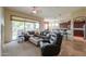 Open-concept living area with neutral decor, tiled floors, and abundant natural light, creating a warm and inviting atmosphere at 20583 N Ryans Trl, Maricopa, AZ 85138