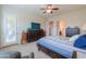 Bright main bedroom with carpet, ceiling fan, dresser, and outdoor access at 20583 N Ryans Trl, Maricopa, AZ 85138