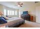 Main bedroom featuring a ceiling fan and access to a backyard patio at 20583 N Ryans Trl, Maricopa, AZ 85138