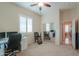 Bright home office features neutral walls, carpet, and shutters, with a mirrored closet and view to an adjacent hall at 20583 N Ryans Trl, Maricopa, AZ 85138