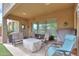 Covered patio with seating area, a fire pit, and views into the landscaped yard at 20583 N Ryans Trl, Maricopa, AZ 85138