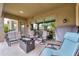 Covered patio with seating area, a fire pit, and views into the landscaped yard at 20583 N Ryans Trl, Maricopa, AZ 85138