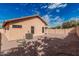 Gravel backyard featuring AC unit, covered patio, and block wall fencing at 21819 N 48Th St, Phoenix, AZ 85054
