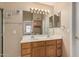 Bathroom featuring double sinks, wood cabinets, and a large framed mirror at 21819 N 48Th St, Phoenix, AZ 85054