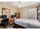 Comfortable bedroom featuring a ceiling fan and a convenient workstation with ample light at 21819 N 48Th St, Phoenix, AZ 85054