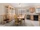 Bright dining area with a wooden table, chairs, and hutch with glass doors at 21819 N 48Th St, Phoenix, AZ 85054