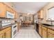 Spacious kitchen with granite countertops, wooden cabinets, and white appliances at 21819 N 48Th St, Phoenix, AZ 85054