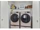 Laundry area boasts a side-by-side washer and dryer and storage shelf at 21819 N 48Th St, Phoenix, AZ 85054