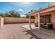 Inviting covered patio with seating, overlooking a spacious gravel backyard and perimeter walls at 21819 N 48Th St, Phoenix, AZ 85054