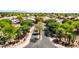 Scenic aerial view of a neighborhood entrance featuring lush landscaping, mature trees, and a well-maintained street at 2476 E Marlene Dr, Gilbert, AZ 85296