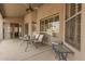 Relaxing back patio with ceiling fan, table and chairs, and access to inside at 2476 E Marlene Dr, Gilbert, AZ 85296