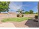 Manicured backyard with synthetic putting green, mature trees and gravel at 2476 E Marlene Dr, Gilbert, AZ 85296