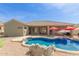 Spacious backyard featuring a pool, mature trees, and covered patio area with grill at 2476 E Marlene Dr, Gilbert, AZ 85296