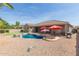 Spacious backyard featuring a pool, mature trees, a grill and covered patio area at 2476 E Marlene Dr, Gilbert, AZ 85296
