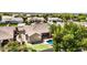 Aerial view of a backyard featuring a pool, putting green, and covered patio area, perfect for outdoor entertaining and relaxation at 2476 E Marlene Dr, Gilbert, AZ 85296