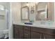 Bathroom featuring dual sinks, dark cabinets, and a shower/tub combo with updated fixtures at 2476 E Marlene Dr, Gilbert, AZ 85296