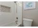 Bright bathroom featuring a shower over tub, modern fixtures, and stylish tiled niche at 2476 E Marlene Dr, Gilbert, AZ 85296