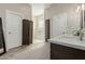 Spacious bathroom with white marble countertops, dark wood cabinets, and large walk-in shower at 2476 E Marlene Dr, Gilbert, AZ 85296