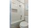 Bright bathroom featuring a shower over tub, modern fixtures, and stylish tiled niche at 2476 E Marlene Dr, Gilbert, AZ 85296