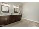 Bathroom with a large, dark wood vanity and dual mirrors offering plenty of counter space at 2476 E Marlene Dr, Gilbert, AZ 85296