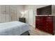 Bedroom features wood floors, updated shutters, and a deep red dresser with TV at 2476 E Marlene Dr, Gilbert, AZ 85296