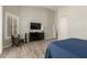 Bright bedroom featuring light wood floors, a black dresser, and modern shutters at 2476 E Marlene Dr, Gilbert, AZ 85296