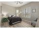 Light-filled bedroom featuring wood floors, a ceiling fan, and window shutters at 2476 E Marlene Dr, Gilbert, AZ 85296