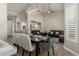 Open-concept dining area with modern light fixture and a view into the comfortable living room at 2476 E Marlene Dr, Gilbert, AZ 85296