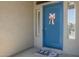 Beautiful blue front door with decorative Easter wreath on a covered front porch at 2476 E Marlene Dr, Gilbert, AZ 85296