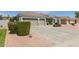 Well-maintained house with a two-car garage, desert landscaping, and mature green shrubs at 2476 E Marlene Dr, Gilbert, AZ 85296