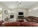 Cozy living room features a fireplace, ceiling fan, and comfortable furniture at 2476 E Marlene Dr, Gilbert, AZ 85296