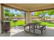 Covered picnic area featuring a table, benches, and grill, perfect for outdoor dining at 2476 E Marlene Dr, Gilbert, AZ 85296