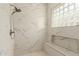 Modern tiled shower with glass block window and built-in bench seating at 2476 E Marlene Dr, Gilbert, AZ 85296